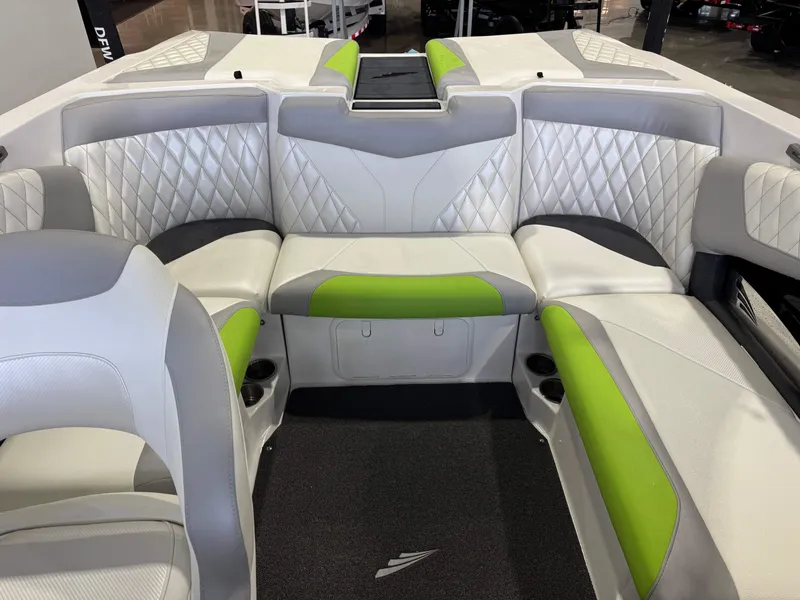 Slide: The Image of Interior of a 2014 Tigé Z1 boat with green and gray seating. - 20