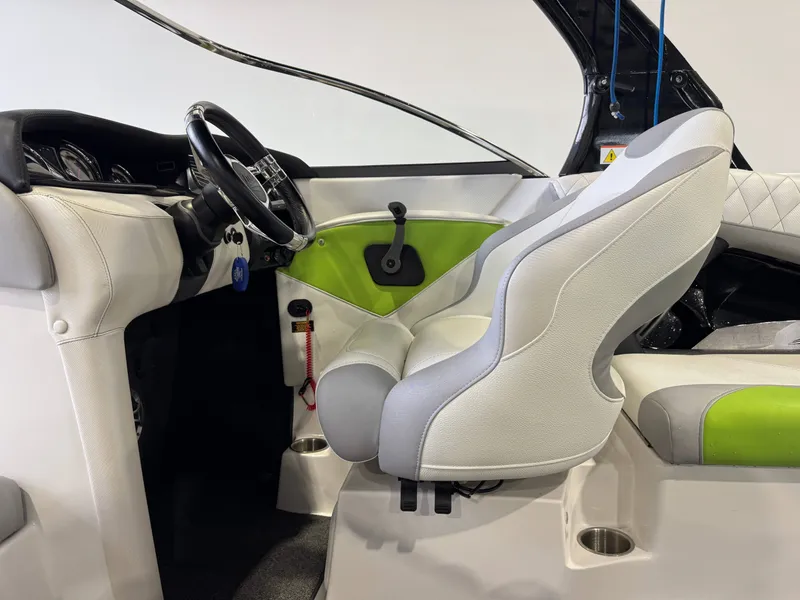 Slide: The Image of Interior of a 2014 Tigé Z1 boat with green accent. - 21