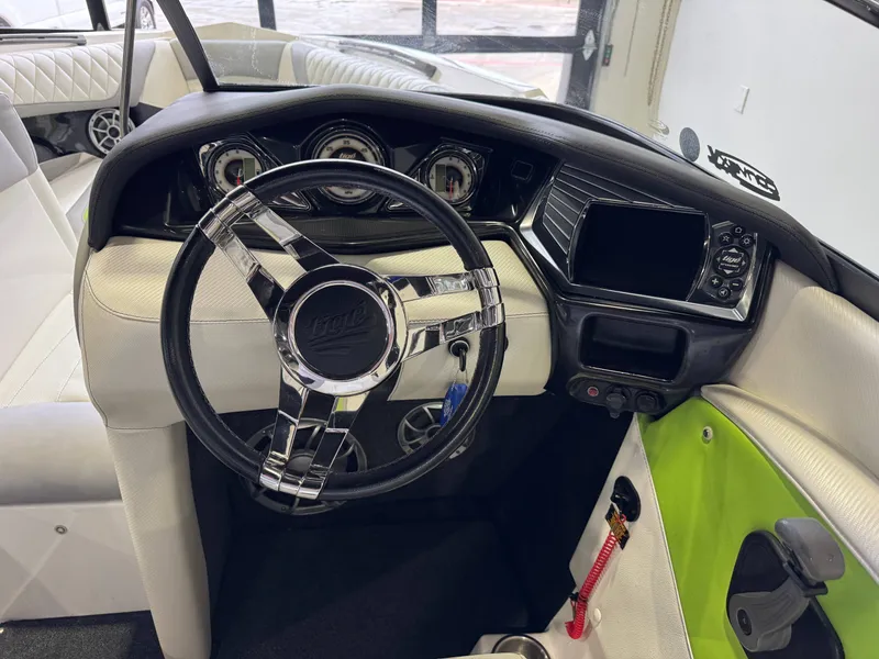 Slide: The Image of Interior of a 2014 Tigé Z1 boat with steering wheel and dashboard. - 24