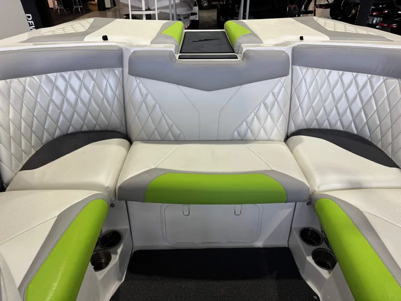 Slide: The Image of Interior of a 2014 Tigé Z1 boat with green and gray seating. - 25