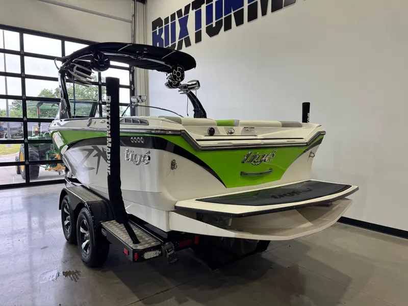 Slide: The Image of 2014 Tigé Z1 boat in a garage, green and white color scheme. - 4