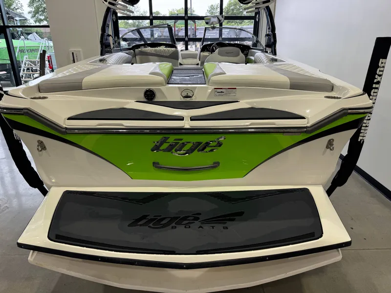 Slide: The Image of 2014 Tigé Z1 boat with green accents in showroom. - 7