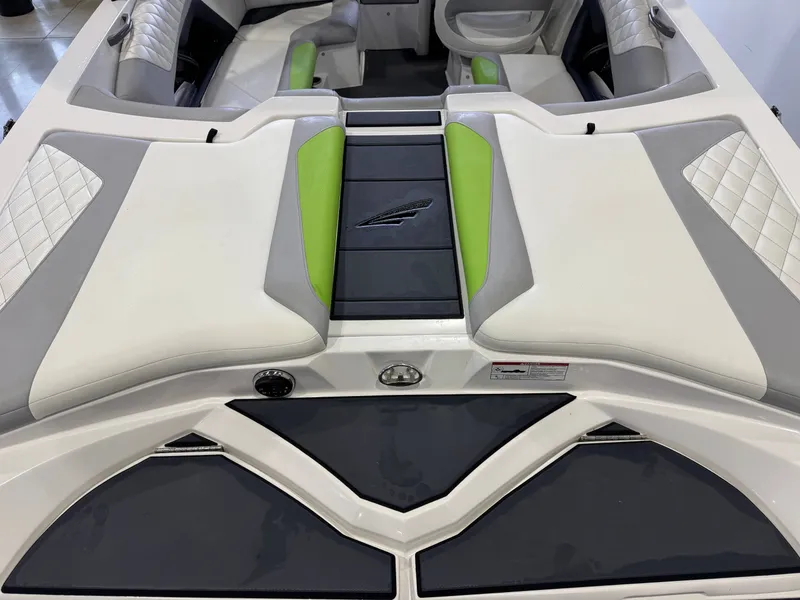 Slide: The Image of Interior of a 2014 Tigé Z1 boat with green and gray upholstery. - 9