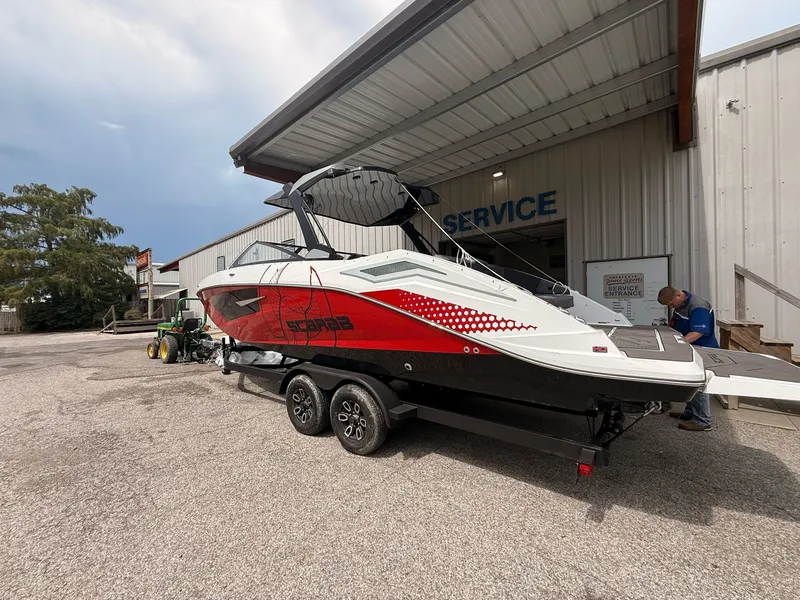 Slide: The Image of 2026 Scarab 285 LX boat parked outside service building. - 11