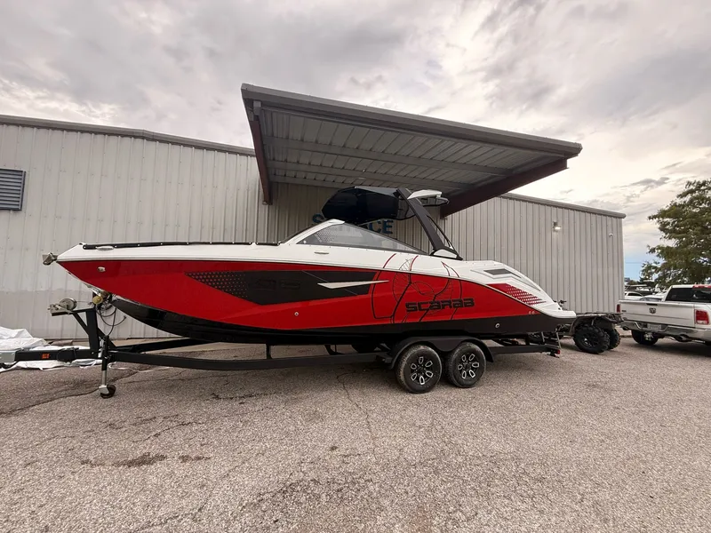 Slide: The Image of 2026 Scarab 285 LX boat on trailer outside building. - 3