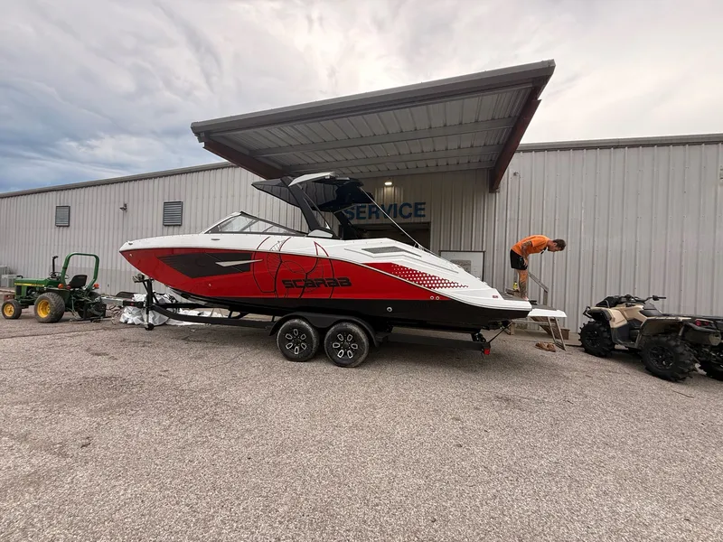 Slide: The Image of 2026 Scarab 285 LX boat parked outside service building. - 4