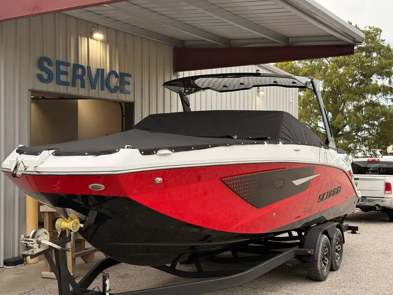 Slide: The Image of 2026 Scarab 285 LX boat parked in service area. - 5