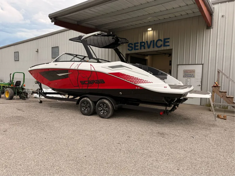 Slide: The Image of 2026 Scarab 285 LX boat parked outside service building. - 8