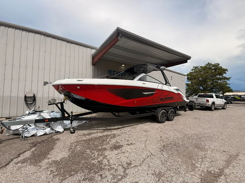 Slide: The Image of 2026 Scarab 285 LX boat on trailer outside warehouse. - 9