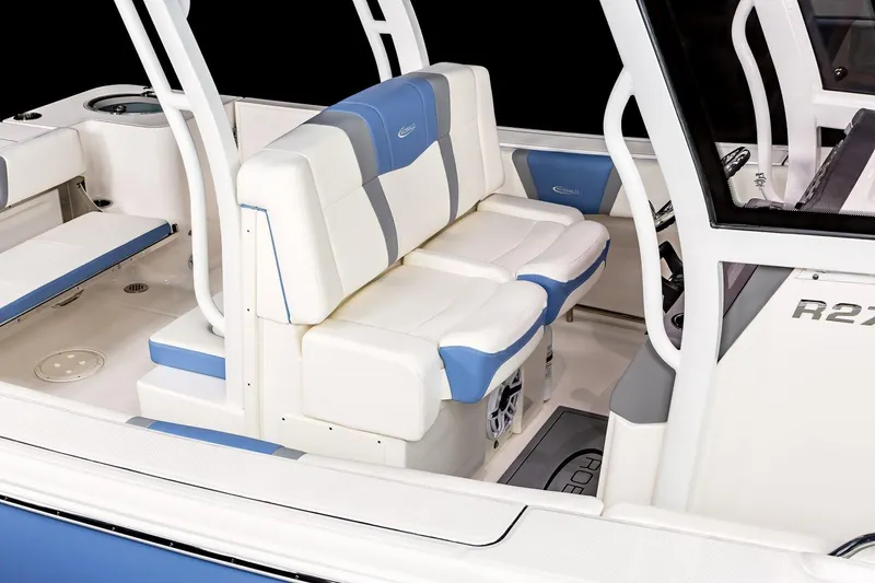 Slide: The Image of Manufacturer Provided Image: 2025 Robalo R270 Center Console boat interior with white and blue seating. - 5