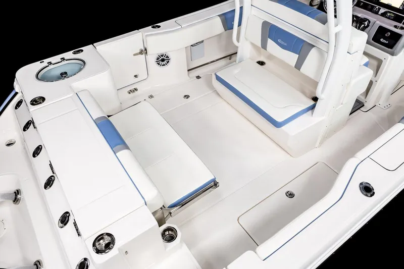 Slide: The Image of Manufacturer Provided Image: 2025 Robalo R270 Center Console boat interior with white and blue seating, spacious layout. - 8