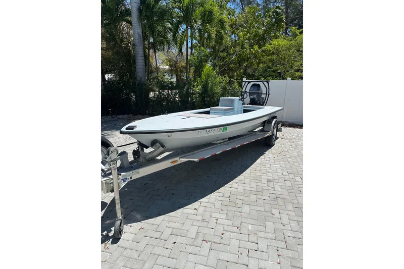 The Image of 2025 Chittum Skiffs 18 Islamorada boat on trailer, parked on paved driveway. - 1