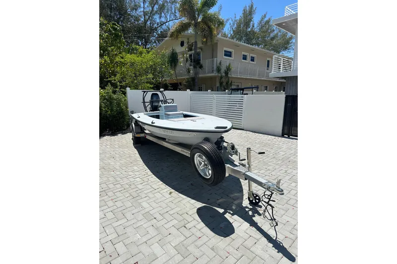 Slide: The Image of 2025 Chittum Skiffs 18 Islamorada boat on trailer in sunny driveway. - 4