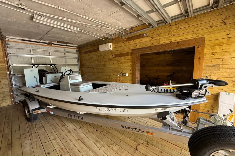 Slide: The Image of 2025 Chittum Skiffs 18 Islamorada boat in wooden garage on trailer. - 16