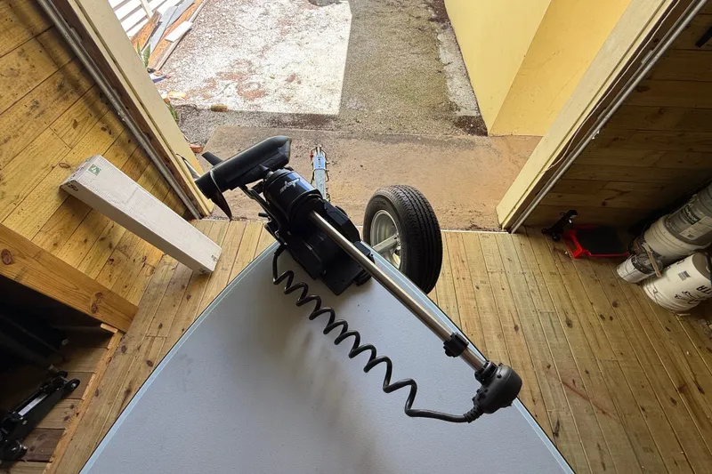 Slide: The Image of 2025 Chittum Skiffs 18 Islamorada boat with motor in wooden garage. - 15