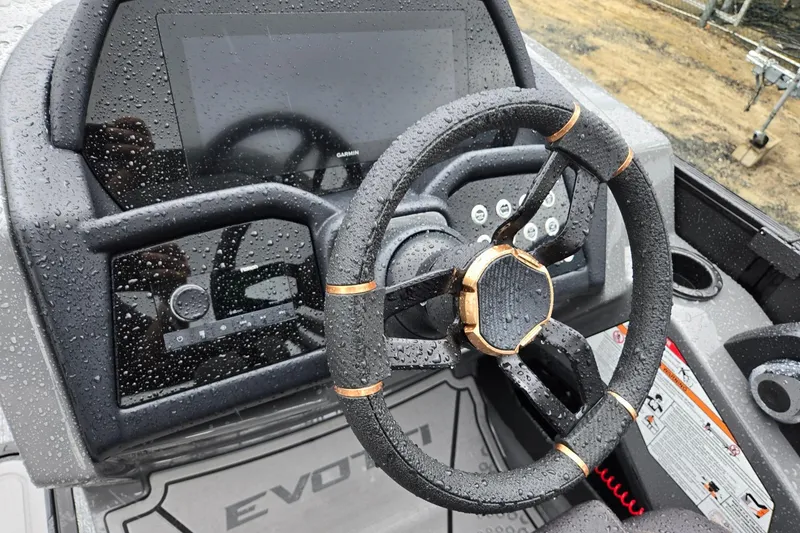 Slide: The Image of Steering wheel of 2026 Evotti 721QL boat, wet with raindrops, featuring modern dashboard. - 14