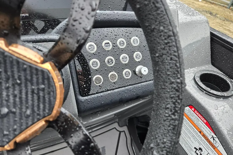 Slide: The Image of Steering wheel and control panel of 2026 Evotti 721QL, wet with raindrops. - 17