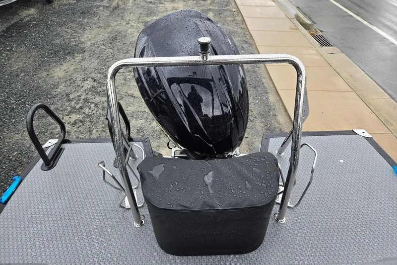 Slide: The Image of Rear view of 2026 Evotti 721QL boat motor with raindrops on a metal platform. - 24