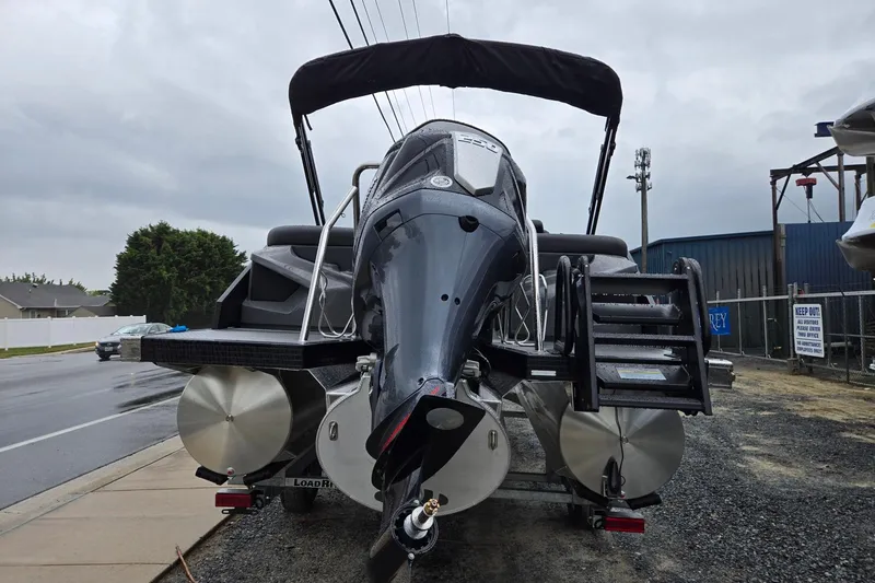 Slide: The Image of 2026 Evotti 721QL boat with sleek design, parked on a trailer, under cloudy skies. - 3