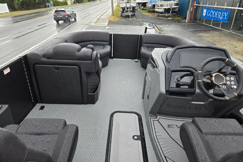Slide: The Image of Interior of 2026 Evotti 721QL boat with modern seating and steering wheel, wet from rain. - 30