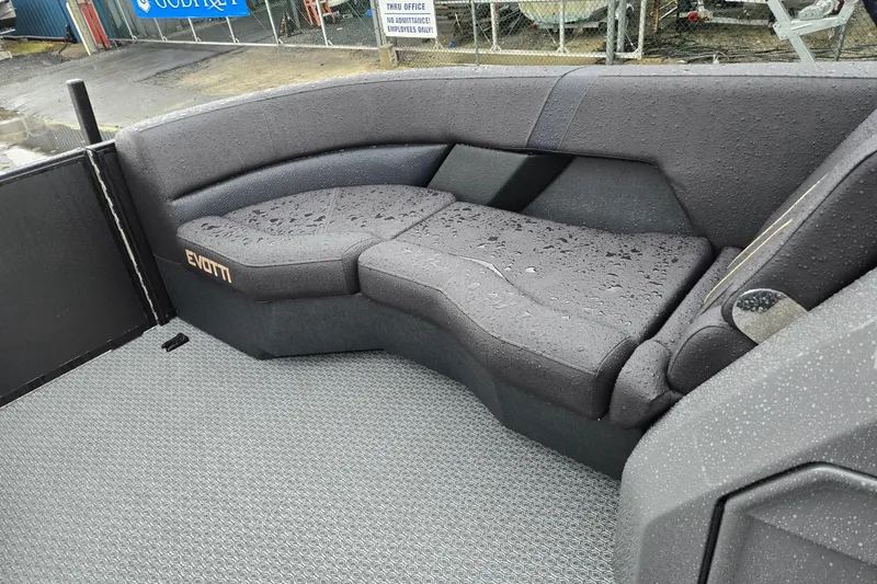 Slide: The Image of Gray seating area on a 2026 Evotti 721QL boat, wet from rain. - 34