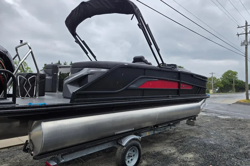 Slide: The Image of 2026 Evotti 721QL pontoon boat on trailer, featuring sleek black and red design. - 4