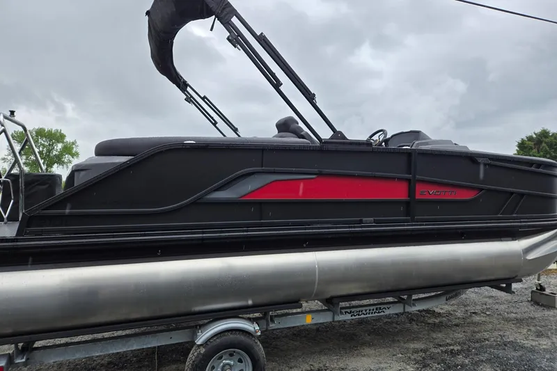 Slide: The Image of 2026 Evotti 721QL pontoon boat on trailer, featuring sleek black and red design. - 5