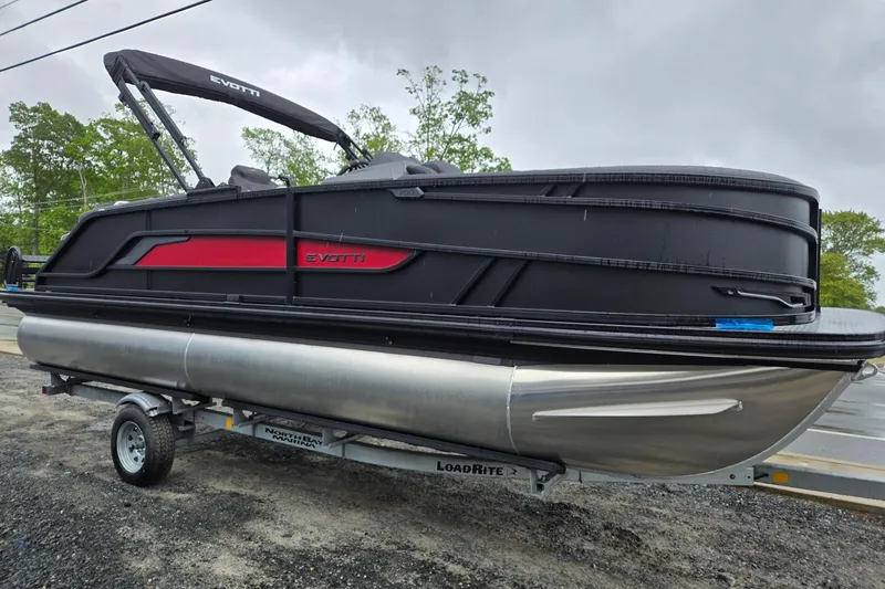 Slide: The Image of 2026 Evotti 721QL pontoon boat on trailer, featuring sleek black and red design. - 6