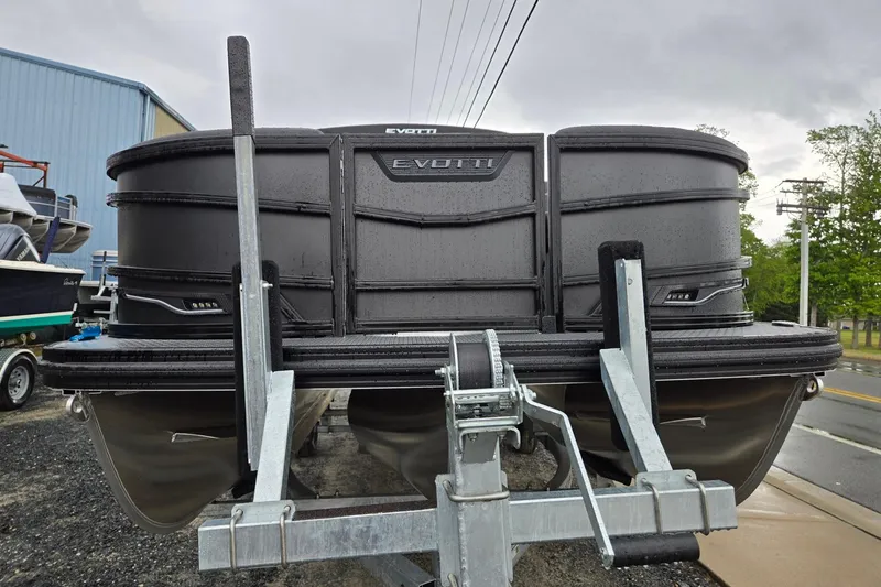 Slide: The Image of Front view of a 2026 Evotti 721QL boat on a trailer, parked outdoors. - 7