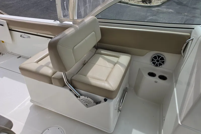 Slide: The Image of 2019 Sailfish 275 DC boat interior with beige seating and cup holders. - 10