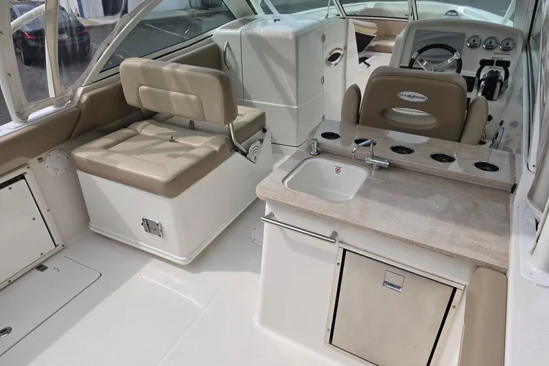 Slide: The Image of 2019 Sailfish 275 DC boat interior with seating, sink, and control panel. - 6