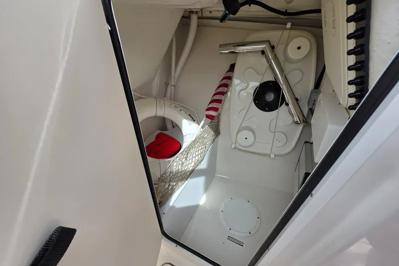 Slide: The Image of Storage compartment of a 2019 Sailfish 275 DC boat with safety equipment. - 9
