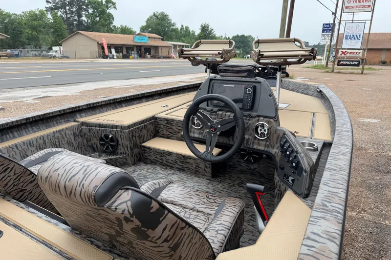 Slide: The Image of 2026 Xpress H18C Crappie boat interior with camo design and advanced navigation system. - 6