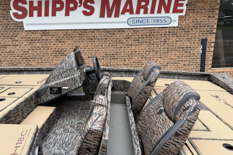 Slide: The Image of 2026 Xpress H18C Crappie boat interior at Shipp's Marine, featuring camo design and seating. - 8