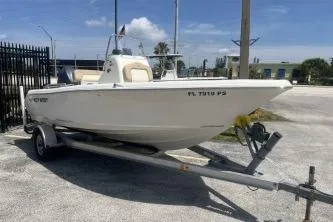 The Image of 2014 Key West 189 FS boat on trailer, parked outdoors under a clear sky. - 1