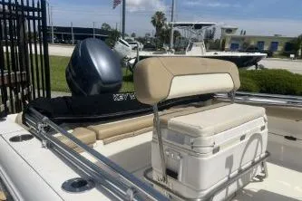 Slide: The Image of 2014 Key West 189 FS boat with seating and outboard motor in a marina setting. - 12