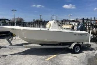 Slide: The Image of 2014 Key West 189 FS boat on trailer, parked outdoors under a clear sky. - 5