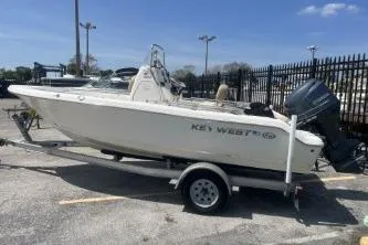 Slide: The Image of 2014 Key West 189 FS boat on trailer, parked outdoors under clear sky. - 6