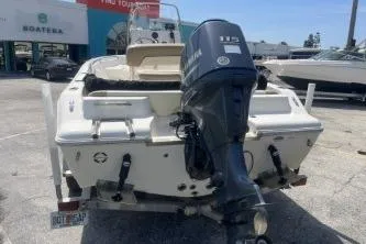 Slide: The Image of 2014 Key West 189 FS boat with Yamaha 115 engine, parked outdoors. - 7