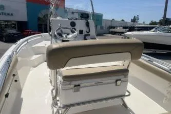 Slide: The Image of 2014 Key West 189 FS boat interior with steering console and cushioned seating. - 8