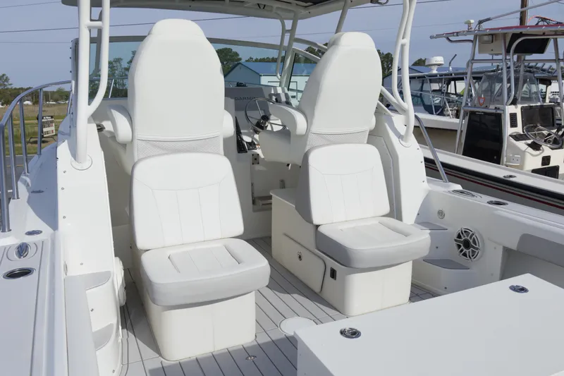 Slide: The Image of 2020 Parker 2810 XLD Walkaround boat interior with white seating and helm station. - 12