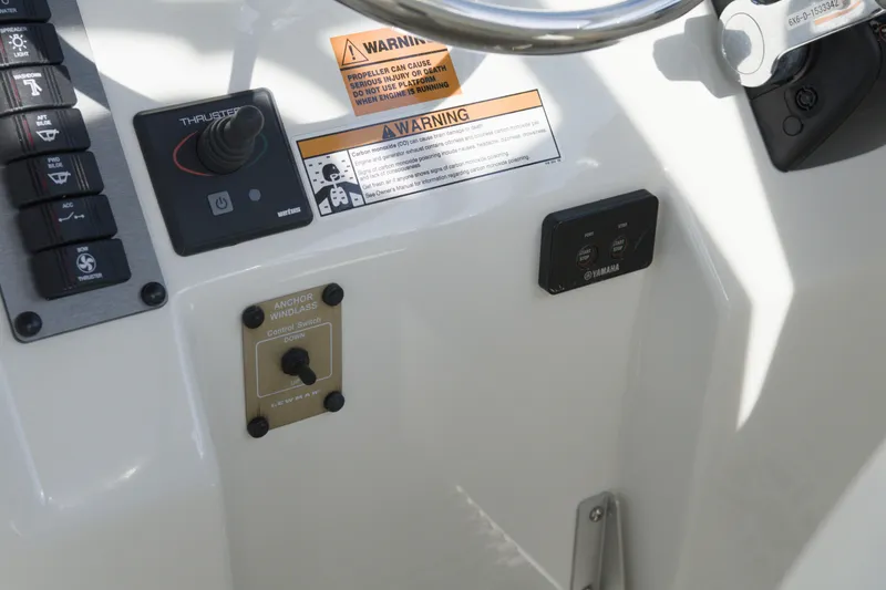 Slide: The Image of Control panel of 2020 Parker 2810 XLD Walkaround boat with warning labels and switches. - 26