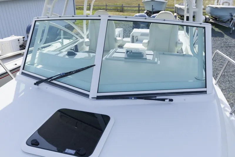 Slide: The Image of 2020 Parker 2810 XLD Walkaround boat with windshield and wipers, docked outdoors. - 28