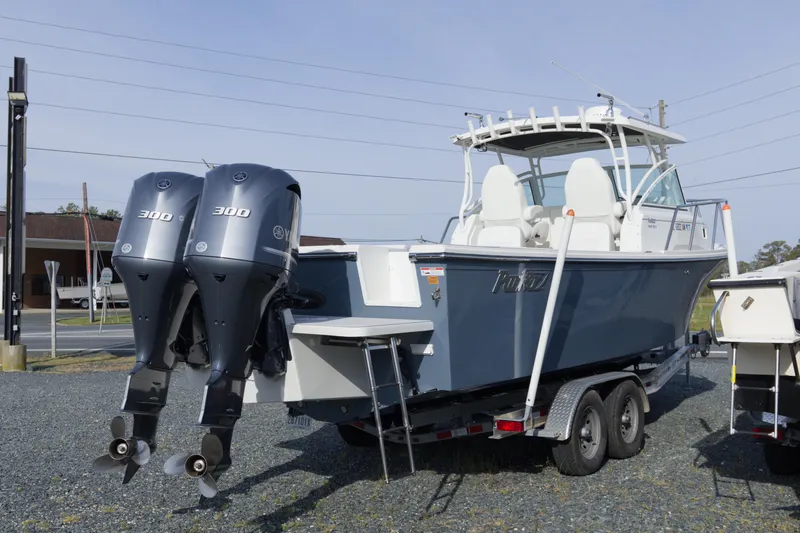 Slide: The Image of 2020 Parker 2810 XLD Walkaround boat with dual 300 horsepower engines on a trailer. - 3