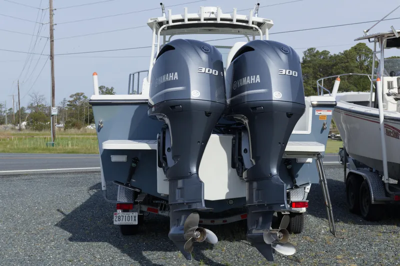 Slide: The Image of 2020 Parker 2810 XLD Walkaround boat with twin Yamaha 300 engines, parked outdoors. - 5