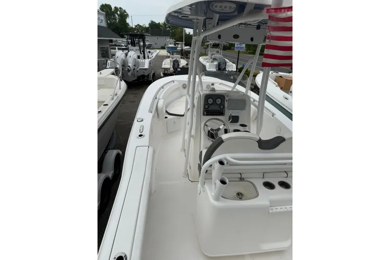 Slide: The Image of 2015 Tidewater 232 CC Adventure boat interior with steering console and seating. - 4