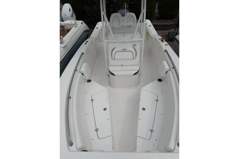 Slide: The Image of 2015 Tidewater 232 CC Adventure boat interior with seating and storage compartments. - 5