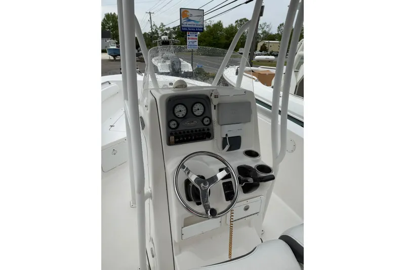 Slide: The Image of 2015 Tidewater 232 CC Adventure boat console with steering wheel and gauges. - 9