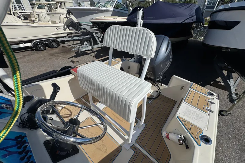 Slide: The Image of 2005 Scout 175 Sportfish boat interior with steering wheel and seating. - 11