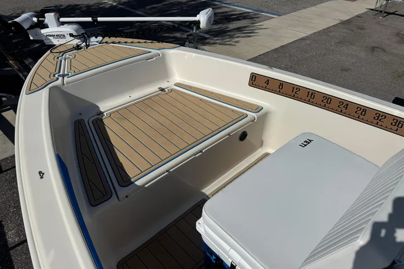 Slide: The Image of 2005 Scout 175 Sportfish boat interior with Minn Kota motor and Yeti cooler. - 2